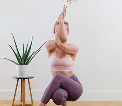 Woman performing half-crane pose