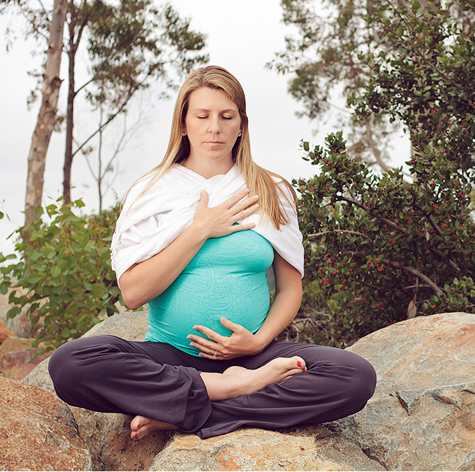 Woman meditating on a rock